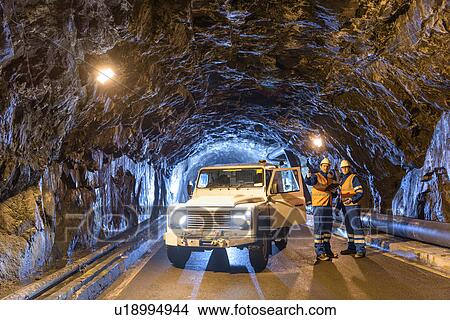 Picture - Workers with utility vehicle in tunnel of hydroelectric power station. Fotosearch