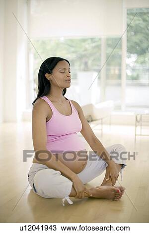 Stock Image - Yoga in pregnancy. Fotosearch