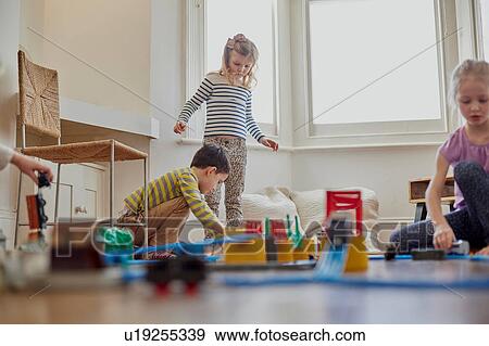 Stock Photo - Young children playing with toy train set. Fotosearch