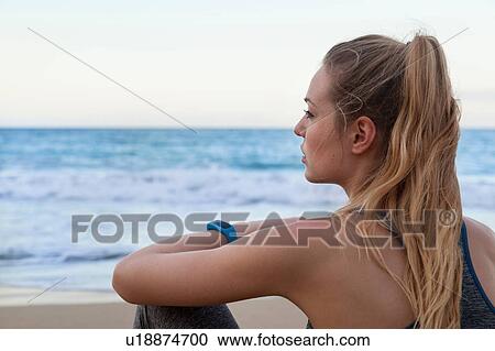 Stock Image - Young female runner wearing smartwatch on beach, Dominican Republic, The Caribbean. Fotosearch