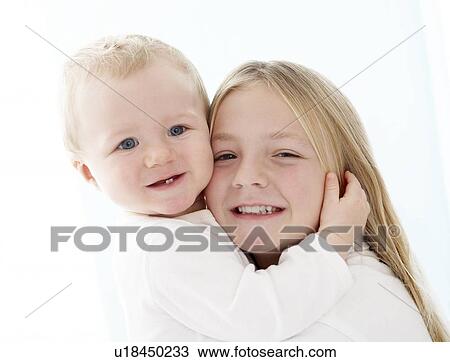 Stock Image - Young girl and baby. Fotosearch