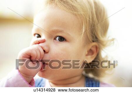 Stock Photo - Young girl sucking her thumb. Fotosearch