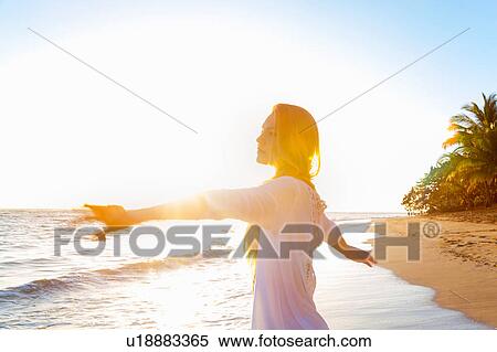 Young woman dancing on beach at sunset, Dominican Republic, The Caribbean View Large Photo Image Stock Photography - Young woman dancing on beach at sunset, Dominican Republic, The Caribbean. Fotosearch