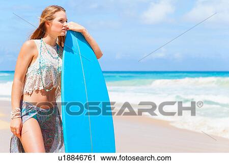 Young woman leaning against surfboard on beach, Dominican Republic, The Caribbean View Large Photo Image Stock Image - Young woman leaning against surfboard on beach, Dominican Republic, The Caribbean. Fotosearch
