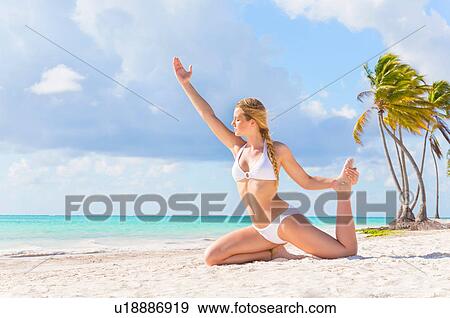 Young woman practicing yoga on beach, Dominican Republic, The Caribbean View Large Photo Image Stock Photo - Young woman practicing yoga on beach, Dominican Republic, The Caribbean. Fotosearch