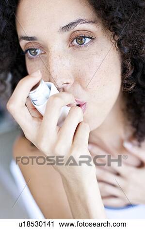 Stock Image - Asthma inhaler use. Fotosearch