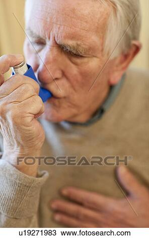 Stock Image - Asthma inhaler use. Fotosearch