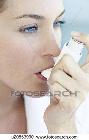 Stock Image - Asthma inhaler use. Fotosearch