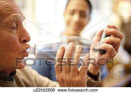 Stock Photograph - Asthma spacer use. Fotosearch