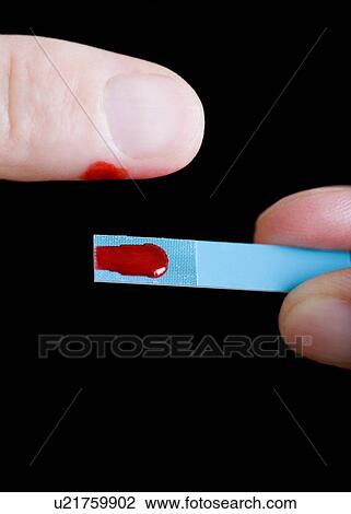 Stock Image - Blood glucose test. Fotosearch