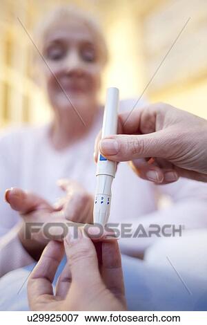 Stock Photo - Blood glucose test. Fotosearch