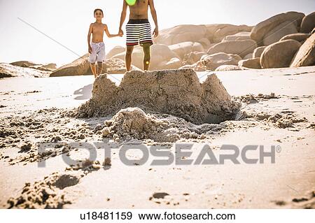 Boy and father strolling on sandcastle beach, Cape Town, South Africa View Large Photo Image Stock Photo - Boy and father strolling on sandcastle beach, Cape Town, South Africa. Fotosearch