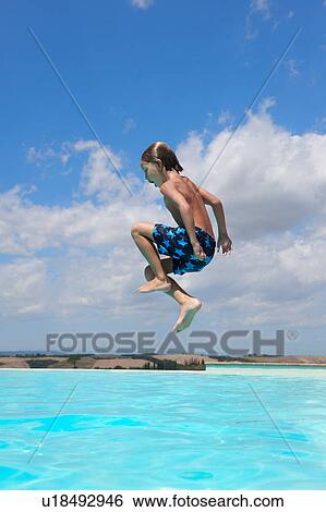 Boy jumping into swimming pool, Buonconvento, Tuscany, Italy View Large Photo Image Stock Photograph - Boy jumping into swimming pool, Buonconvento, Tuscany, Italy. Fotosearch