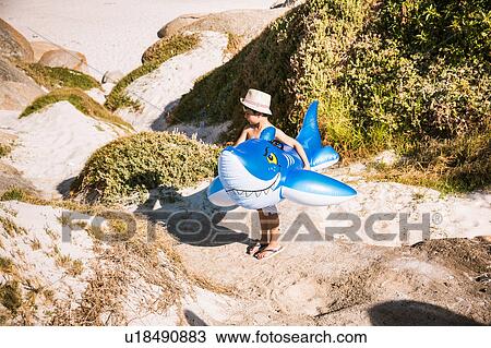 Boy standing in sand dune carrying shark inflatable, Cape Town, South Africa View Large Photo Image Stock Image - Boy standing in sand dune carrying shark inflatable, Cape Town, South Africa. Fotosearch