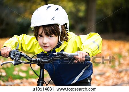 Boy wearing bicycle helmet on bicycle looking at camera View Large Photo Image Stock Image - Boy wearing bicycle helmet on bicycle looking at camera. Fotosearch