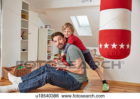 Boy wearing boxing gloves hugging father View Large Photo Image Stock Photograph - Boy wearing boxing gloves hugging father. Fotosearch