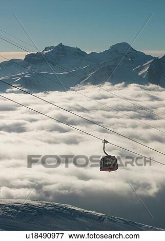 Stock Photo - Cable car moving up from mountain fog in the Alps, Bettmeralp, Valais, Switzerland. Fotosearch