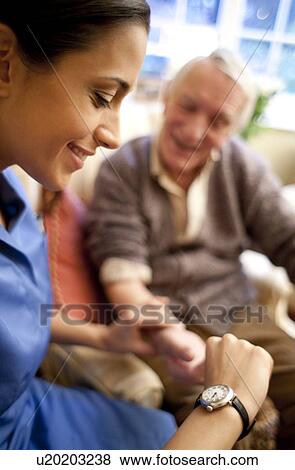 Checking pulse View Large Photo Image Stock Photo - Checking pulse. Fotosearch