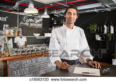 Chef in restaurant looking at camera View Large Photo Image Stock Image - Chef in restaurant looking at camera. Fotosearch