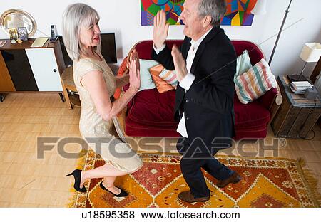 Couple dressed up and dancing at home View Large Photo Image Stock Photo - Couple dressed up and dancing at home. Fotosearch