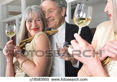 Couple dressed up and having drink in front of mirror View Large Photo Image Stock Photography - Couple dressed up and having drink in front of mirror. Fotosearch