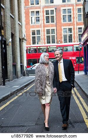 Stock Photograph - Couple dressed up and out walking on street. Fotosearch