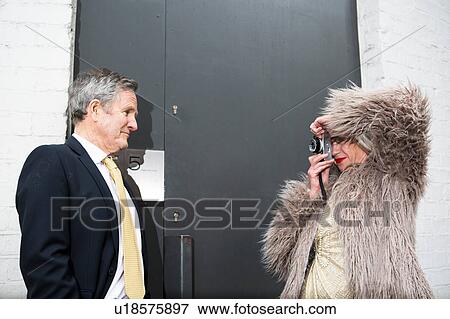 Couple dressed up and taking photograph in front of door View Large Photo Image Stock Photo - Couple dressed up and taking photograph in front of door. Fotosearch