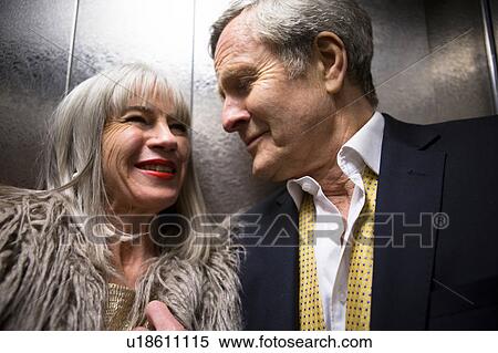 Couple dressed up, in lift View Large Photo Image Stock Photography - Couple dressed up, in lift. Fotosearch