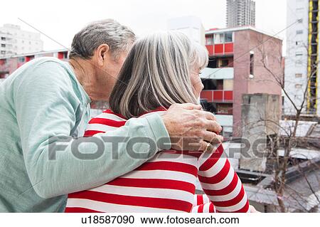 Stock Image - Couple enjoying view on balcony. Fotosearch