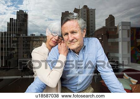 Couple looking through window View Large Photo Image Stock Photo - Couple looking through window. Fotosearch