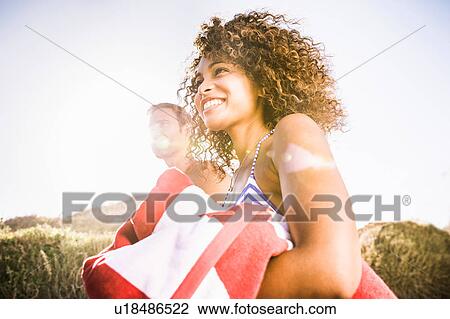 Couple on sand dune carrying beach towel, Cape Town, South Africa View Large Photo Image Stock Image - Couple on sand dune carrying beach towel, Cape Town, South Africa. Fotosearch