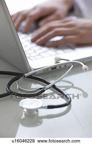 Stock Photo - Doctor working on a laptop. Fotosearch