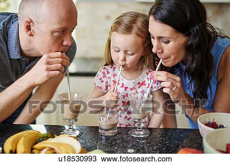 Family drinking smoothie with straws View Large Photo Image Stock Image - Family drinking smoothie with straws. Fotosearch