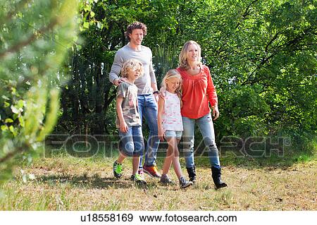 Family walking together in forest View Large Photo Image Stock Photo - Family walking together in forest. Fotosearch