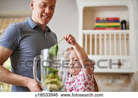Father and daughter adding ingredients to blender View Large Photo Image Stock Photograph - Father and daughter adding ingredients to blender. Fotosearch