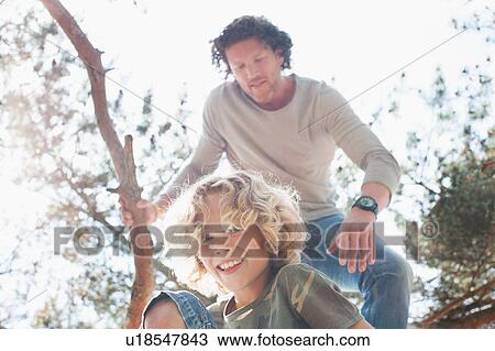 Father and son climbing tree View Large Photo Image Stock Image - Father and son climbing tree. Fotosearch