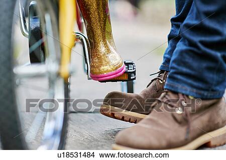 Feet of father and daughter with bicycle View Large Photo Image Picture - Feet of father and daughter with bicycle. Fotosearch