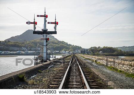 Stock Image - Ffestiniog railway tracks at coast, Porthmadog, Wales, UK. Fotosearch