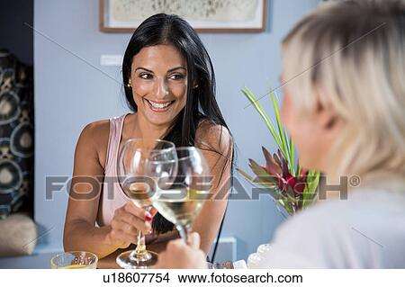 Friends enjoying wine during lunch in restaurant View Large Photo Image Picture - Friends enjoying wine during lunch in restaurant. Fotosearch