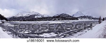 Stock Image - Frozen lake and snow covered mountains, Engadin, Switzerland. Fotosearch