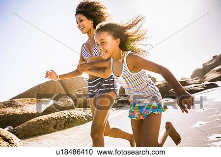 Girl and mother running on beach, Cape Town, South Africa View Large Photo Image Stock Image - Girl and mother running on beach, Cape Town, South Africa. Fotosearch