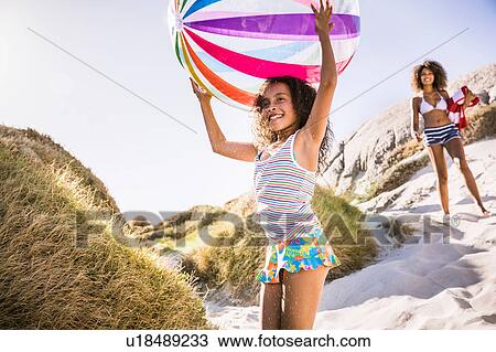 Girl and mother walking down sand dune carrying beachball, Cape Town, South Africa View Large Photo Image Stock Image - Girl and mother walking down sand dune carrying beachball, Cape Town, South Africa. Fotosearch