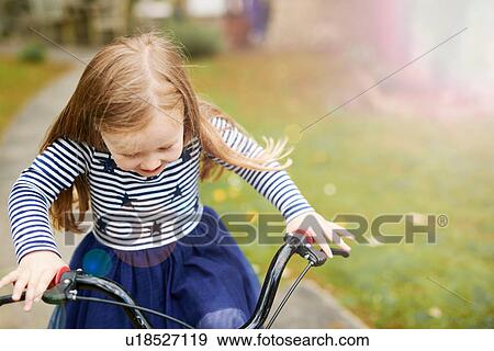 Girl riding bicycle View Large Photo Image Stock Photo - Girl riding bicycle. Fotosearch