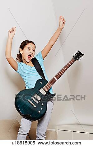 Girl with guitar, mouth open, arms raised in triumph View Large Photo Image Stock Photography - Girl with guitar, mouth open, arms raised in triumph. Fotosearch