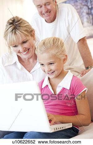 Stock Image - Grandparents and granddaughter. Fotosearch