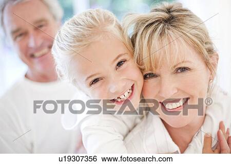 Stock Photograph - Grandparents and granddaughter. Fotosearch