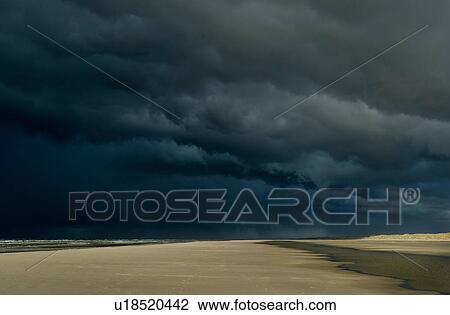 Stock Image - Hailstorm approaching the island of Terschelling from the North Sea, West aan Zee, Friesland, Netherlands. Fotosearch