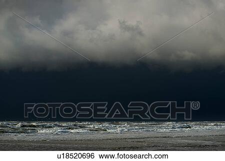 Stock Photograph - Hailstorm approaching the island of Terschelling from the North Sea, West aan Zee, Friesland, Netherlands. Fotosearch