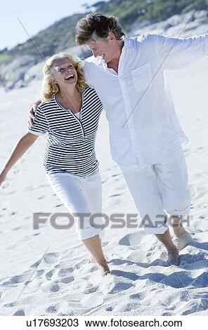 Happy couple on a beach View Large Photo Image Stock Image - Happy couple on a beach. Fotosearch