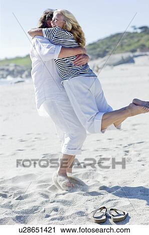 Happy couple on a beach View Large Photo Image Stock Image - Happy couple on a beach. Fotosearch